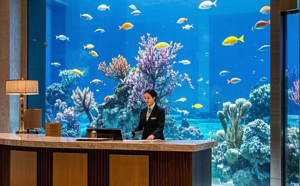 A giant acrylic fish tank for seafood viewing at the hotel front desk