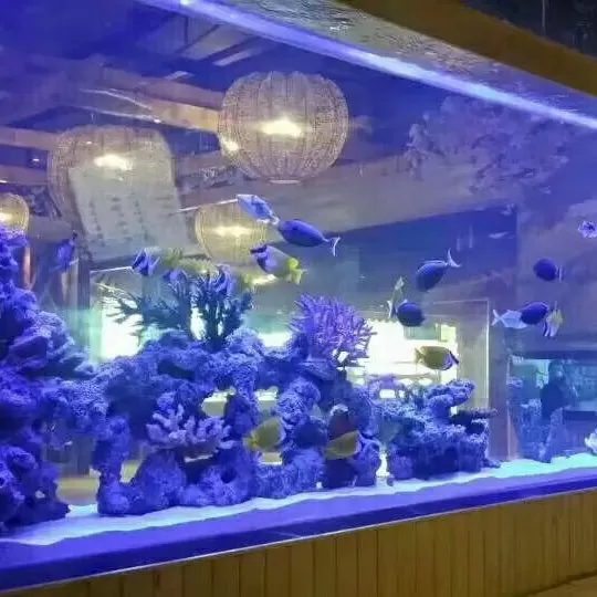 Custom-made floor-standing long wood-grain base cabinets and large acrylic ornamental fish tanks